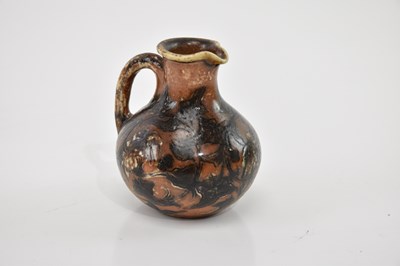 Lot 357 - MARTIN BROTHERS; a small bulbous jug with...