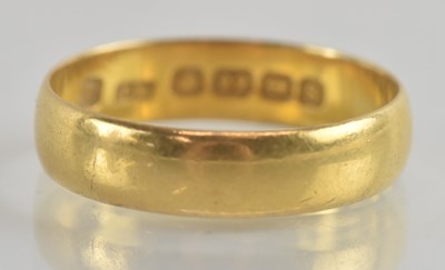 Lot 1240 - A 22ct gold band ring, size X, approx 5.4g.
