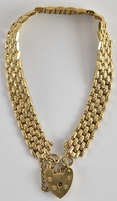 Lot 1338 - A 9ct gold gate bracelet, with 9ct gold heart...