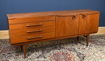 Lot 1445 - A mid century teak sideboard, with an...