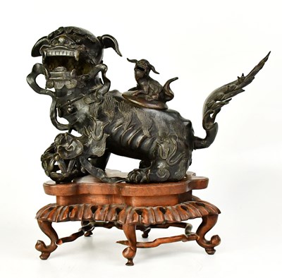 Lot 353 - A Chinese bronze incense burner in the form of...