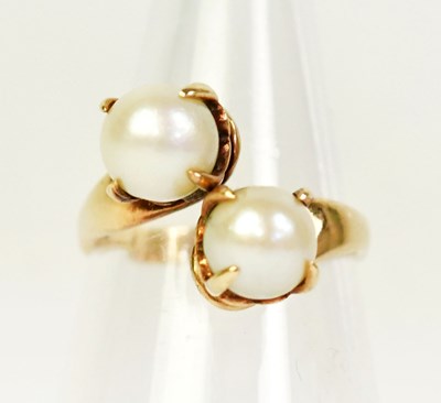 Lot 1345 - A 9ct yellow gold ring set with two pearls,...