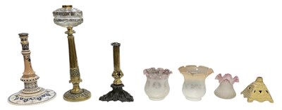 Lot 105 - Four oil lamp bases, including a late...