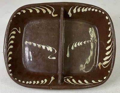 Lot 234 - A 19th century treacle glazed slipware two...