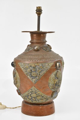 Lot 2352 - A Malaysian copper and brass lamp, decorated...
