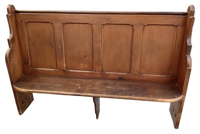 Lot 22 - A late 19th century stained pine church pew,...