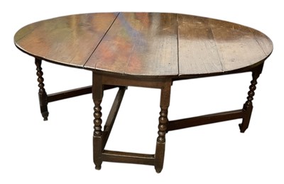 Lot 14 - An 18th century oak oval gateleg drop-leaf...