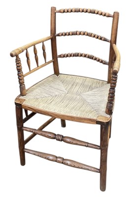 Lot 48 - A 19th century oak bobbin turned rush seated...