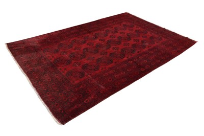 Lot 1303 - A large Bokhara type red ground carpet, with...