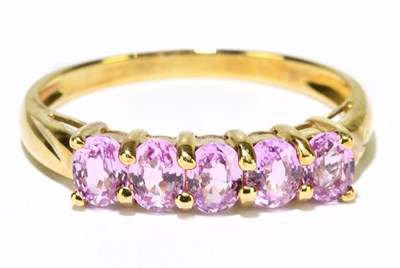 Lot 1234 - A 9ct yellow gold five stone pink sapphire,...