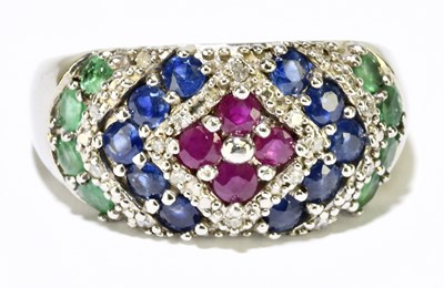 Lot 1157 - A 9ct white gold multi gem set broad ring,...