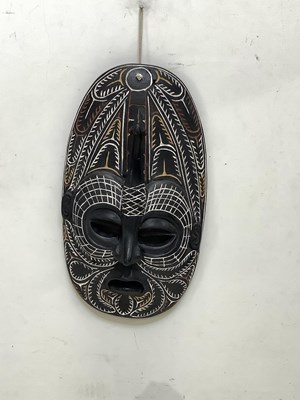 Lot 1532 - A Papua New Guinea carved black painted mask,...