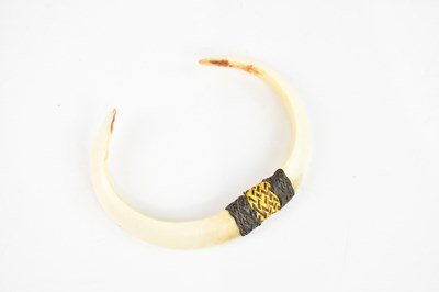 Lot 1553 - A Papua New Guinea pig tusk pendant, length 11cm.