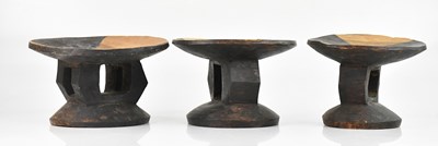 Lot 1536 - A group of three African carved graduated...