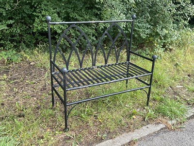 Lot 239 - A black painted Gothic style garden bench,...