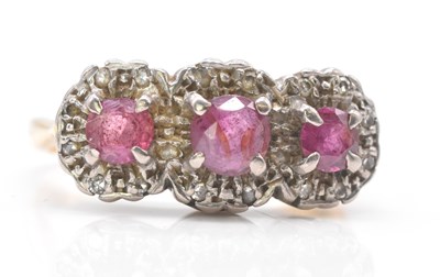 Lot 1011 - An 18ct yellow gold ruby and diamond triple...