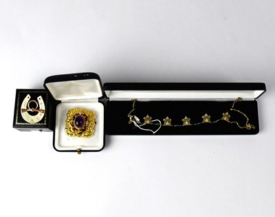 Lot 1144 - A yellow metal square filigree brooch/pendant...