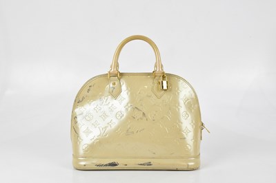 Lot 179 - LOUIS VUITTON; a cream patent leather 'Alma PM...