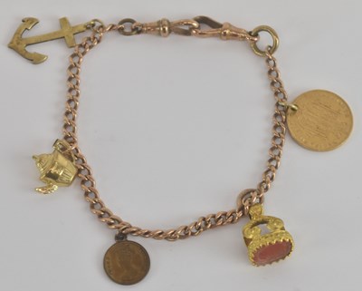 Lot 1497 - A 9ct yellow gold charm bracelet, suspending...