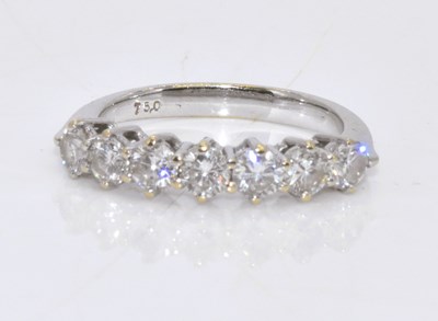 Lot 1015 - An 18ct white gold seven stone diamond half...