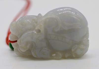 Lot 473 - A Chinese mutton fat jade carving, depicting a...