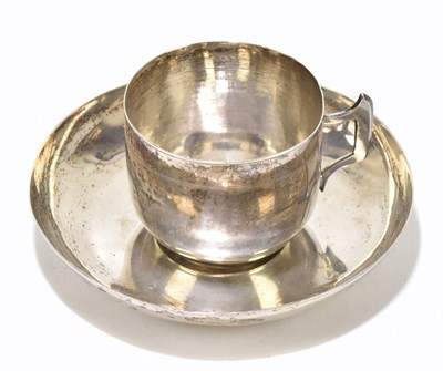 Lot 1151 - An Indian white metal tea cup and saucer