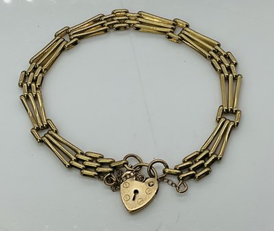 Lot 1029 - A 9ct yellow gold gate link bracelet with...
