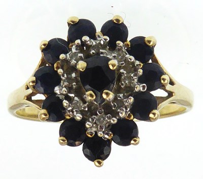 Lot 1047 - A 9ct gold sapphire and diamond cluster ring,...