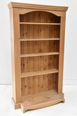 Lot 33 - A modern pine breakfront open bookcase, with...