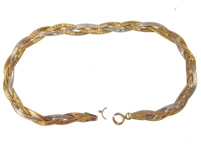 Lot 1112 - A two-colour 9ct gold flat strand bracelet,...