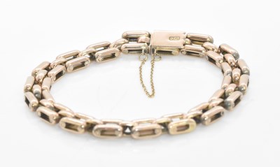 Lot 1041 - A 9ct gold gate link bracelet, length approx....