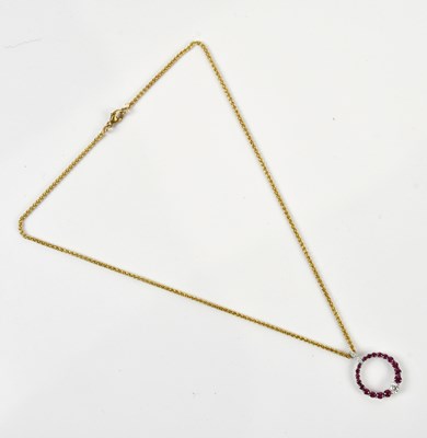 Lot 2082 - An 18ct white gold circular synthetic ruby and...