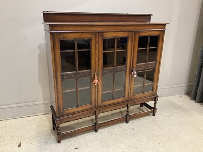 Lot 2019 - An early 20th century oak display cabinet with...