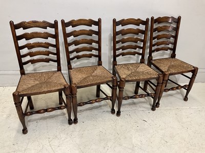 Lot 2079 - A set of four rush seated ladder back chairs.