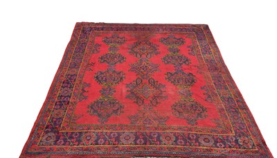 Lot 55 - A large antique Oushak carpet, with geometric...