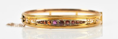 Lot 34 - A 9ct yellow gold hinged snap bangle, set with...