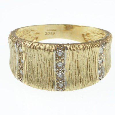 Lot 1071 - A 1970s-style 9ct gold ring with textured top...