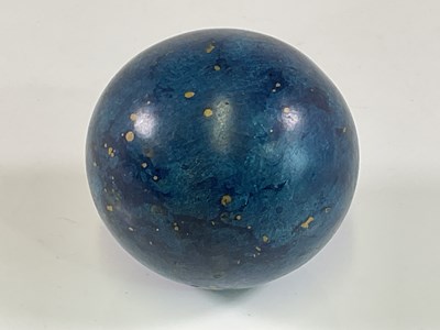 Lot 33 - A wooden ball with painted simulated blue...