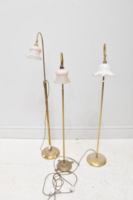 Lot 619 - Three modern brass lamps, largest 150cm.