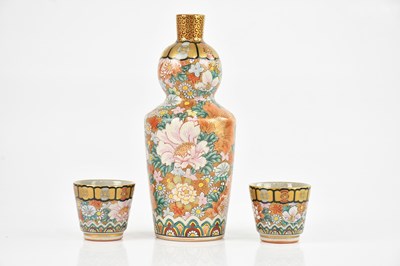 Lot 1664 - A Japanese Kutani sake bottle and two cups,...