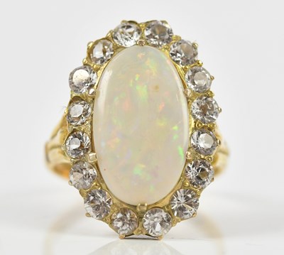 Lot 2450 - A yellow metal opal set dress ring flanked,...