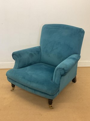 Lot 2802 - A blue upholstered low armchair, raised on...