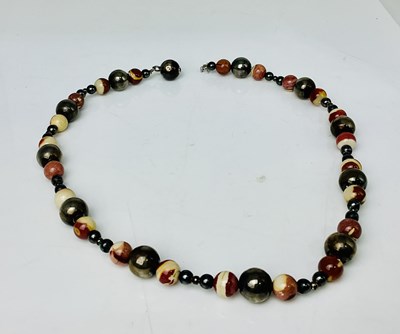 Lot 1018 - TIFFANY & CO; a bead and white metal spacer...