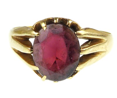 Lot 1017 - An 18ct gold claw set oval garnet ring, size P,...