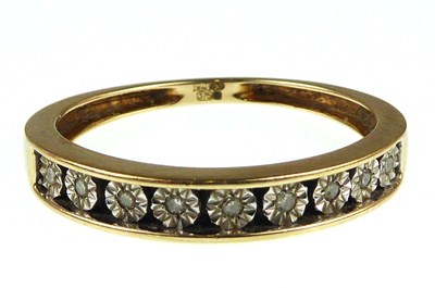 Lot 1065 - A 9ct gold half eternity ring with nine...