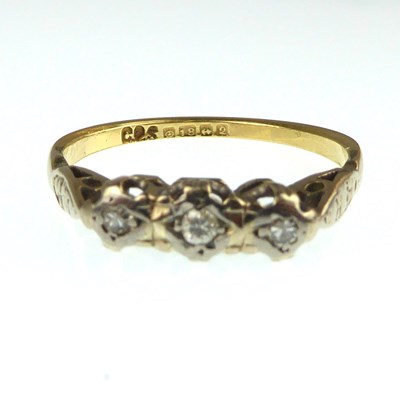 Lot 1021 - An 18ct gold ring with three diamonds set in...