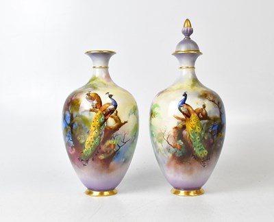 Lot 286 - ROYAL WORCESTER; a pair of lidded vases of...