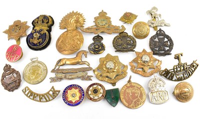Lot 529 - A mixed collection of military cap badges...