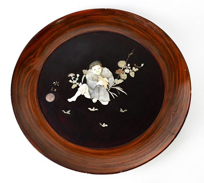 Lot 180 - A Japanese Shibayama roundel depicting a boy...