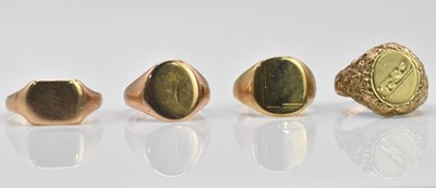 Lot 1051 - Four 9ct gold signet rings, combined approx 19g.